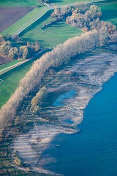 Dry riverside of Rhine in Germany with very low water level after dry summer season