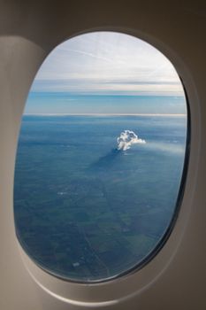 Smoke and steam of a power plant seen from airplane with shadow on the ground