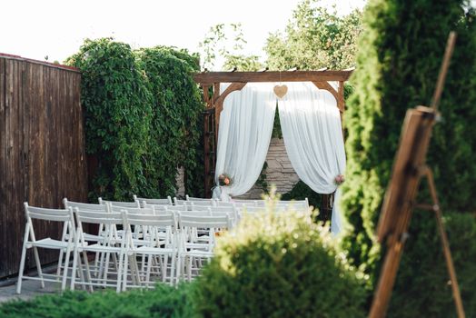 wedding ceremony area, arch chairs decor