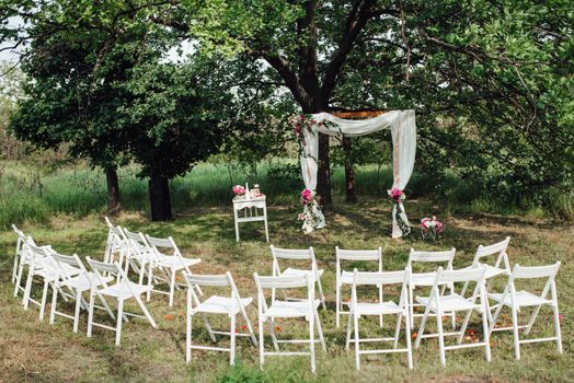 wedding ceremony area, arch chairs decor