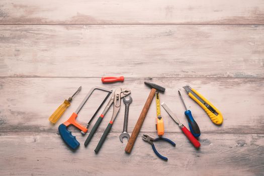 Screwdriver,hammer,tape measure and other tool for construction tools on gray wooden background with copy space,industry engineer tool concept.still-life.