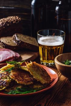 Potato Pancakes and Glass of Beer for Dinner. Vertical.