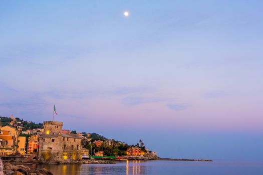 panorama of an italian sea village with space for text and moon high in the sky - Rapallo - italy town copyspace background night sunset