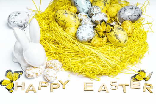 Happy Easter. Easter white bunny on a white background with Easter eggs.Easter greeting card with easter bunny.Happy Easter.