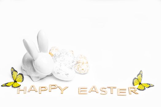 Happy Easter. Easter white bunny on a white background with Easter eggs.Easter greeting card with easter bunny.Happy Easter.