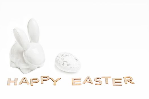 Happy Easter. Easter white bunny on a white background with Easter eggs.Easter greeting card with easter bunny.Happy Easter.