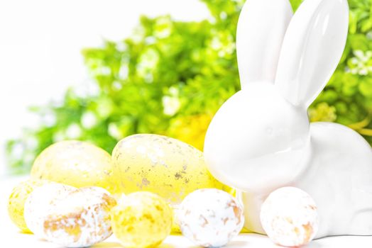 Happy Easter. Easter white bunny on a white background with Easter eggs.Easter greeting card with easter bunny.Happy Easter.