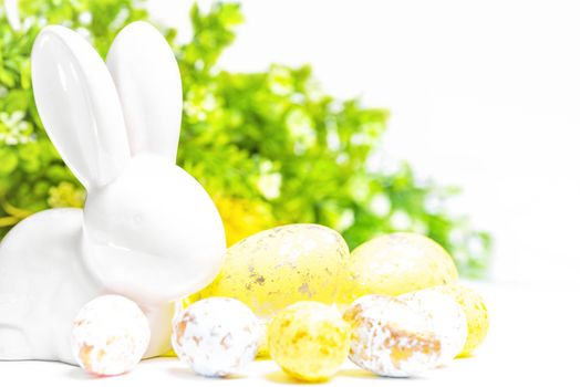Happy Easter. Easter white bunny on a white background with Easter eggs.Easter greeting card with easter bunny.Happy Easter.
