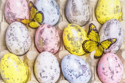 Happy Easter. Multi-colored Easter eggs in the egg cells. Easter card. Close-up.Soft focus.