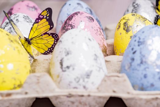 Happy Easter. Multi-colored Easter eggs in the egg cells. Easter card. Close-up.Soft focus.