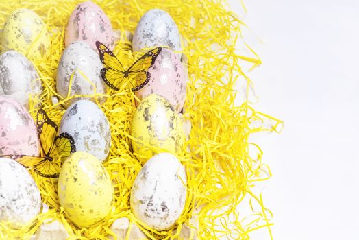 Happy Easter.Multi-colored Easter eggs on a white background with a bunch of wooden letters Happy Easter.