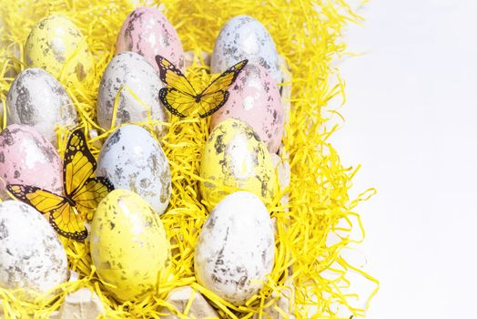 Happy Easter.Multi-colored Easter eggs on a white background with a bunch of wooden letters Happy Easter.