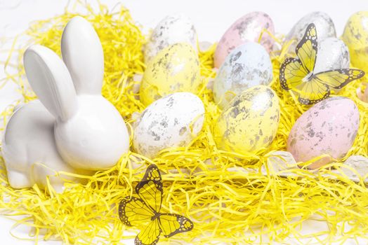 Happy Easter. Easter white bunny on a white background with Easter eggs.Easter greeting card with easter bunny.Happy Easter.