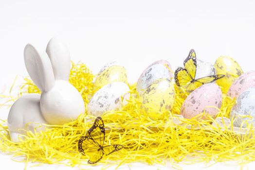 Happy Easter. Easter white bunny on a white background with Easter eggs.Easter greeting card with easter bunny.Happy Easter.