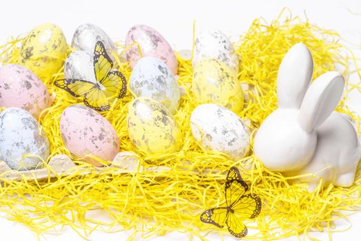 Happy Easter. Easter white bunny on a white background with Easter eggs.Easter greeting card with easter bunny.Happy Easter.