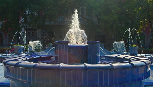 Fountain made of blue marble with water splashing around