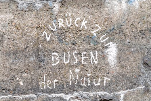 Concrete wall with inscription of the Figure of speech in German, the yellow of the egg
