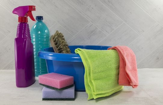 blue washing up dish with cleaning tools and detergents as degreaser and a brush with wipes