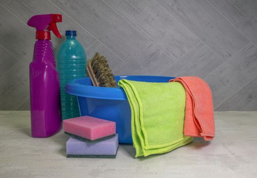 blue washing up dish with cleaning tools and detergents as degreaser and a brush with wipes