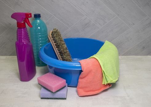 blue washing up dish with cleaning tools and detergents as degreaser and a brush with wipes