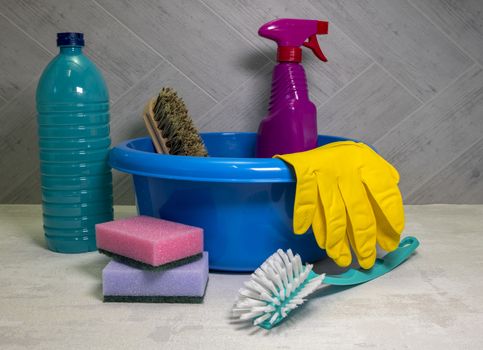 blue washing up dish with cleaning tools and detergents as degreaser and a brush with wipes