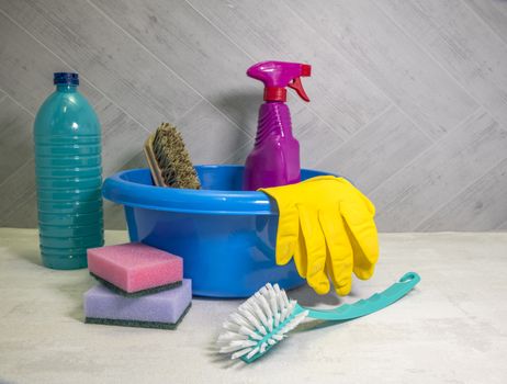blue washing up dish with cleaning tools and detergents as degreaser and a brush with wipes