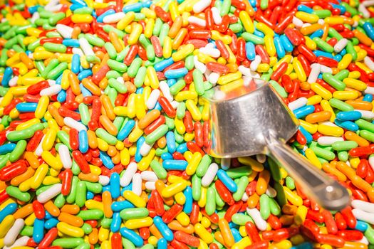 Assorted candy covered licorice with metal spoon. Candy store photo.