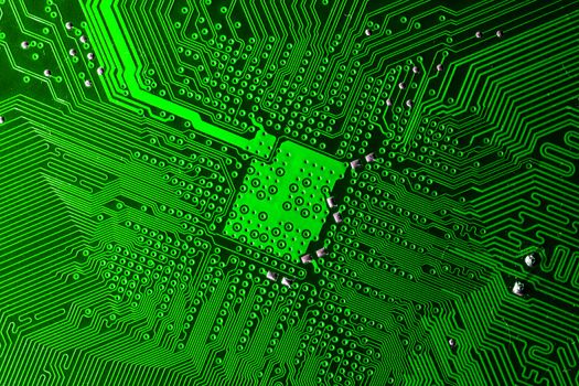 Close up photo of green printecd circuit board with solder points