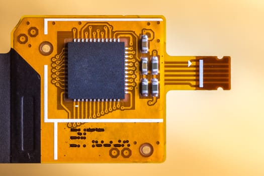 Flex ribbon cable chip from mobile phone. Touch screen controller. on a bright background.