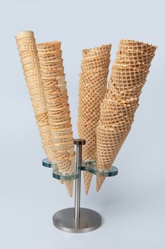 Metal stand with icecream cups on a studio background