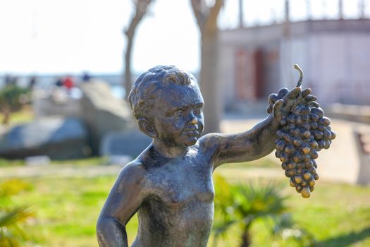 Pomorie, Bulgaria - March 02, 2019: "The Boy with Grapes" - The Statue Symbol Of The Town Of Pomorie.