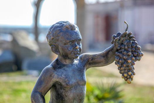 Pomorie, Bulgaria - March 02, 2019: "The Boy with Grapes" - The Statue Symbol Of The Town Of Pomorie.