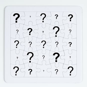 a puzzle with white pieces with an question mark