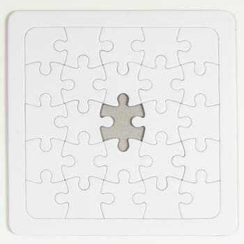 the empty and completely white puzzle with a missing piece