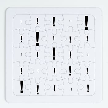 a puzzle with white pieces with the exclamation mark