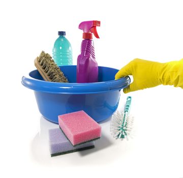 male hand with gloves holding blue washing up dish with cleaning tools and detergents as degreaser and a brush with wipes insulated on white background