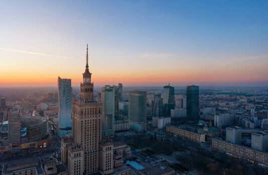 Aerial view of Warsaw business center: Palace of Science and Culture and skyscrapers at sunset