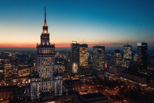 Aerial view of Warsaw business center: Palace of Science and Culture and skyscrapers at sunset