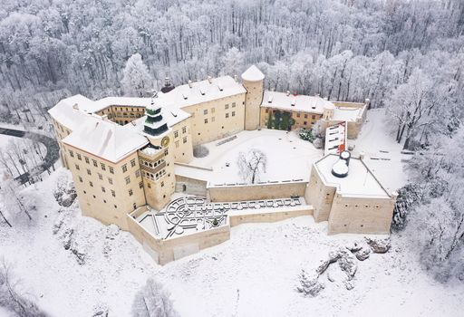 Aerial view oh historic renaissance castle Pieskowa Skala near Krakow in Poland in winter. Built on a steep cliff