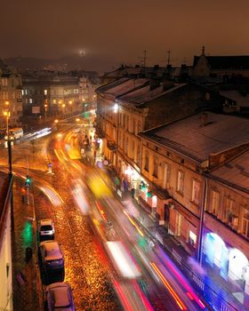 Aerial view of one of the central streets of Lviv at night. Blurred car lights