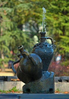 Fountains made as a marble pots with water spraying from one of them