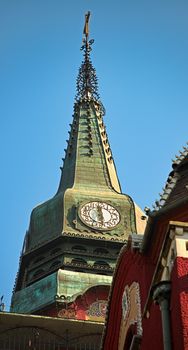 Top of the tower with a clock on a catholic church