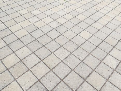 View of floor in square blocks of cement on the diagonal perspective.