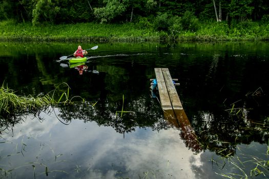 People boating on river Memele in Latvia, peacefull nature scene.