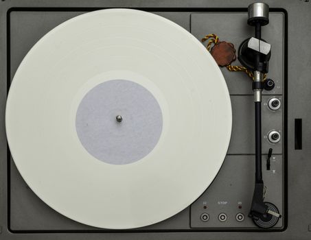 Vintage vinyl turntable with vinyl plate. Listen to music. Top view.