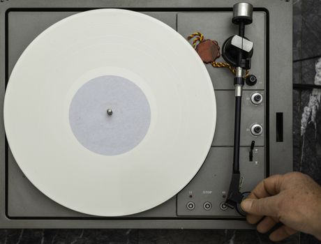 Vintage vinyl turntable with vinyl plate. Listen to music. Top view.