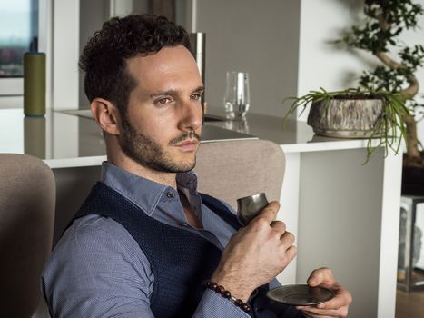 Handsome Man Drinking Coffe from Metal Cup While Sitting Comfortably at Home