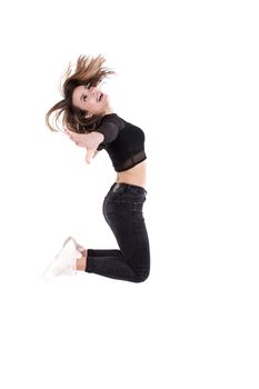 Young dancer girl jumping on white background isolated