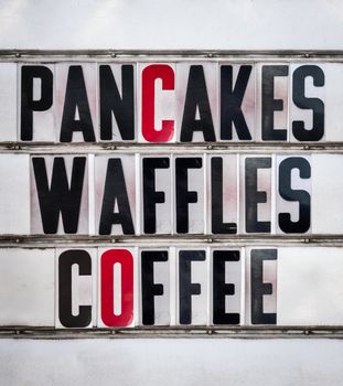 A Retro Vintage And Grungy Sign For A Breakfast Cafe Or Diner Advertising Pancakes, Waffles and Coffee