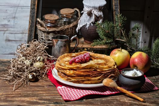Plate with pancakes on an old wooden background
